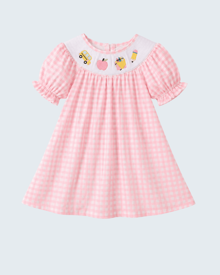 Pink gingham smocked dress with short puff sleeves and bus and apple graphic front
