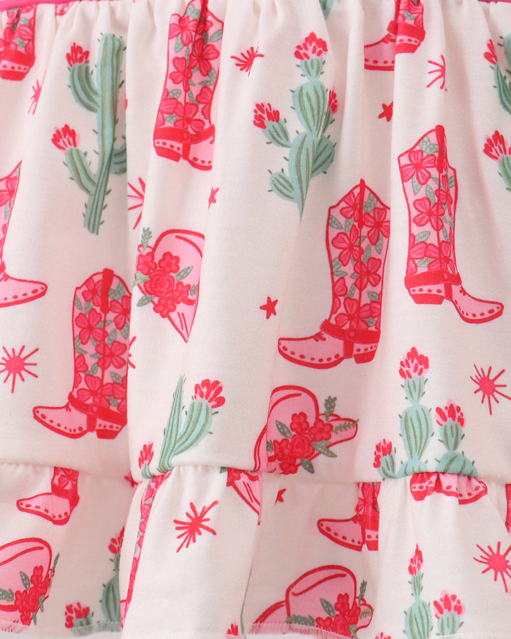 Fabric with cowboy boot and cactus pattern on a white background