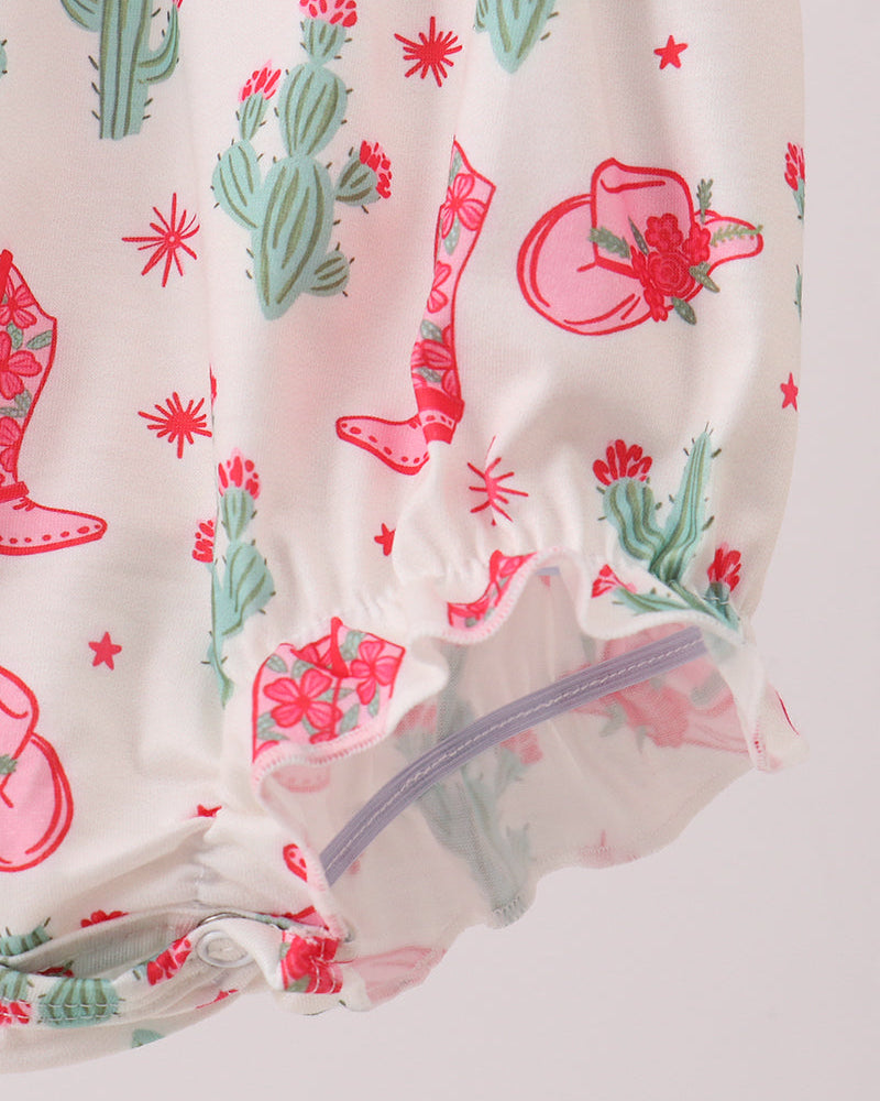Baby romper with cactus, boots, and flower pattern on a light background