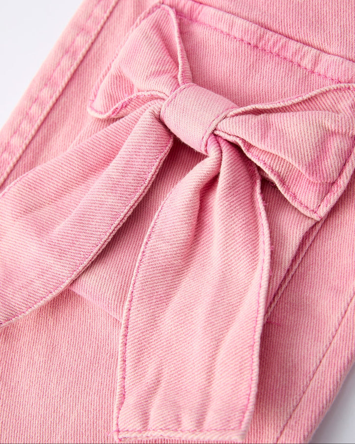 Pink denim pants with a tied bow at the front pocket