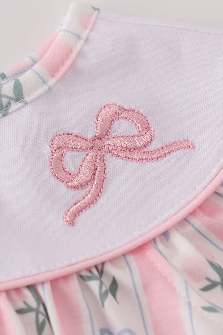 Baby romper with pink bow and floral pattern