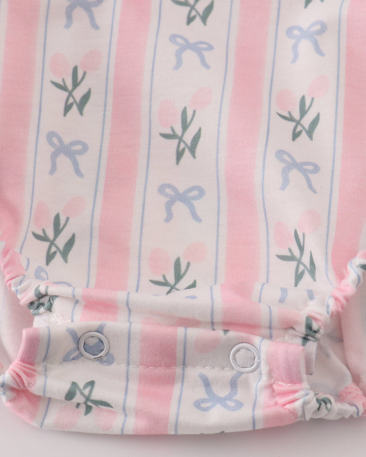 Baby romper with pink and white striped pattern on a light gray background