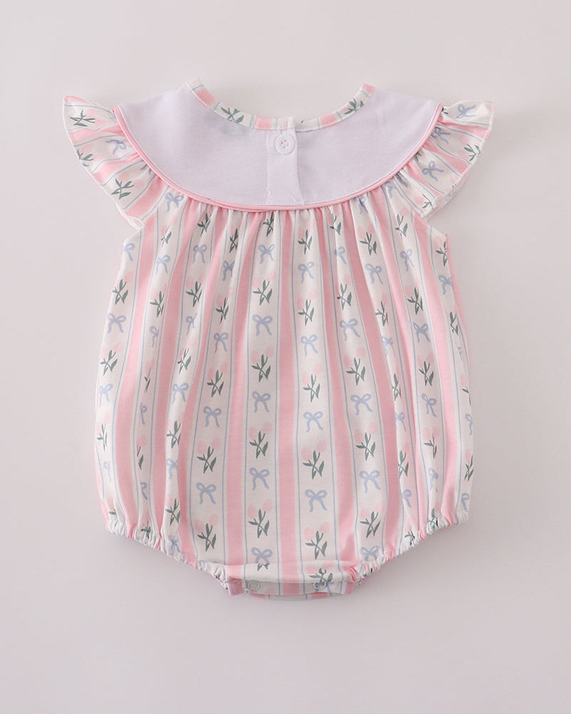 Baby romper with floral pattern on a light gray background