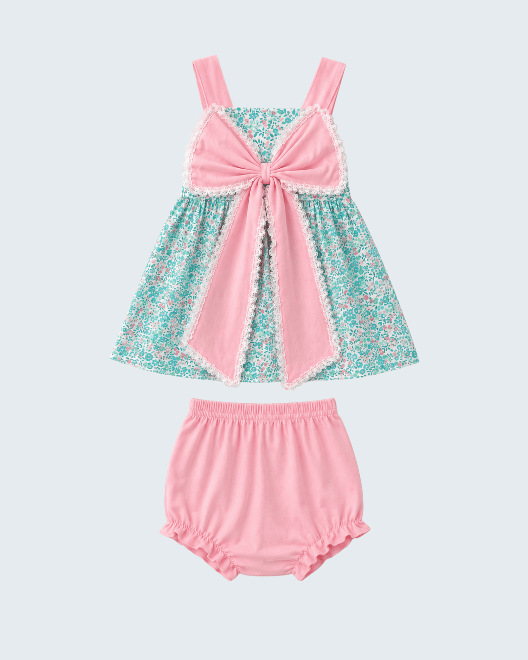 Pink and teal dress with matching bloomers on a light gray background