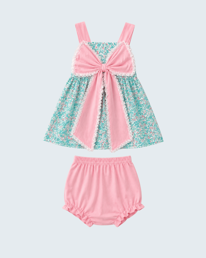 Pink and teal dress with matching bloomers on a light gray background