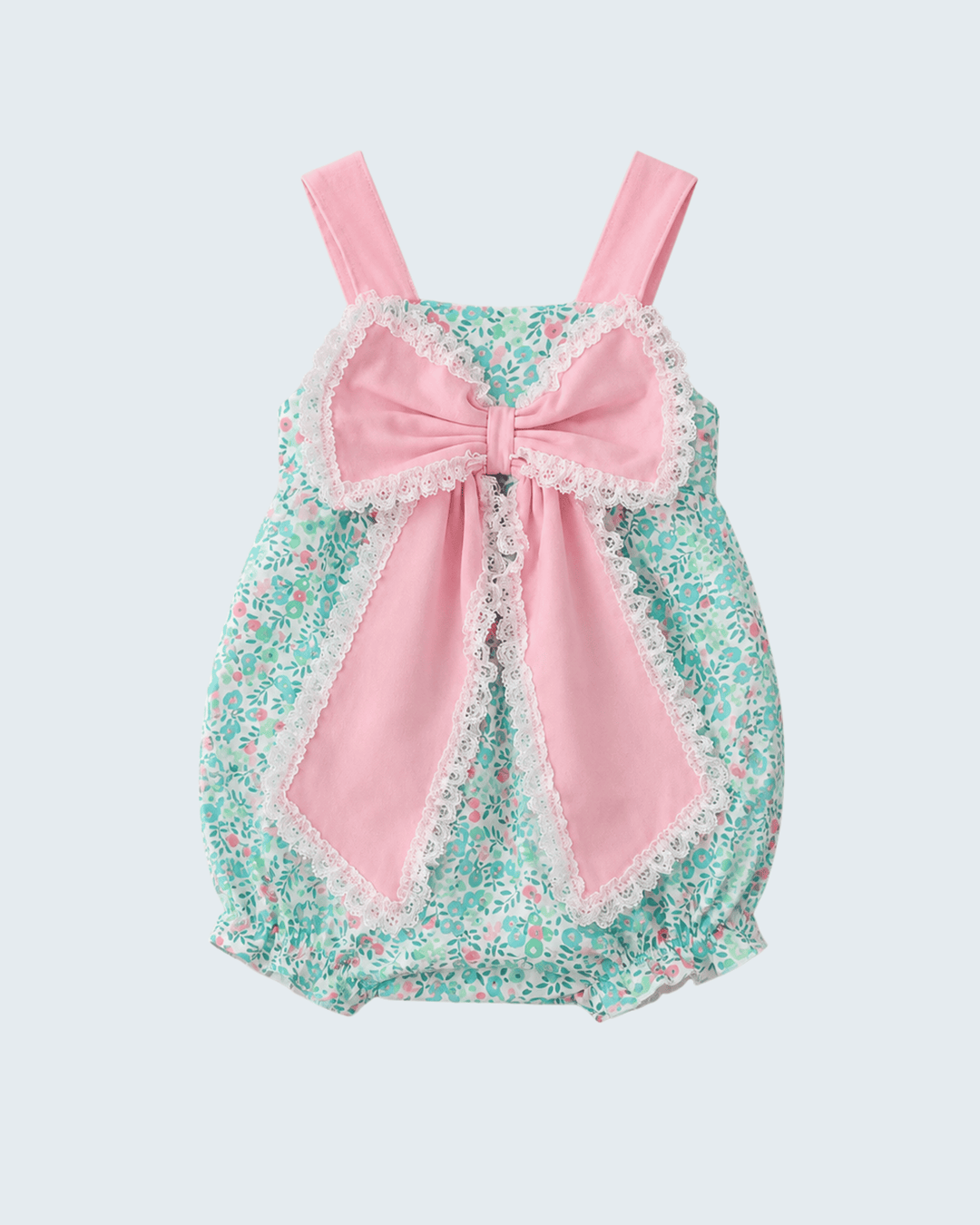 Baby romper with floral pattern and pink bow on a light gray background