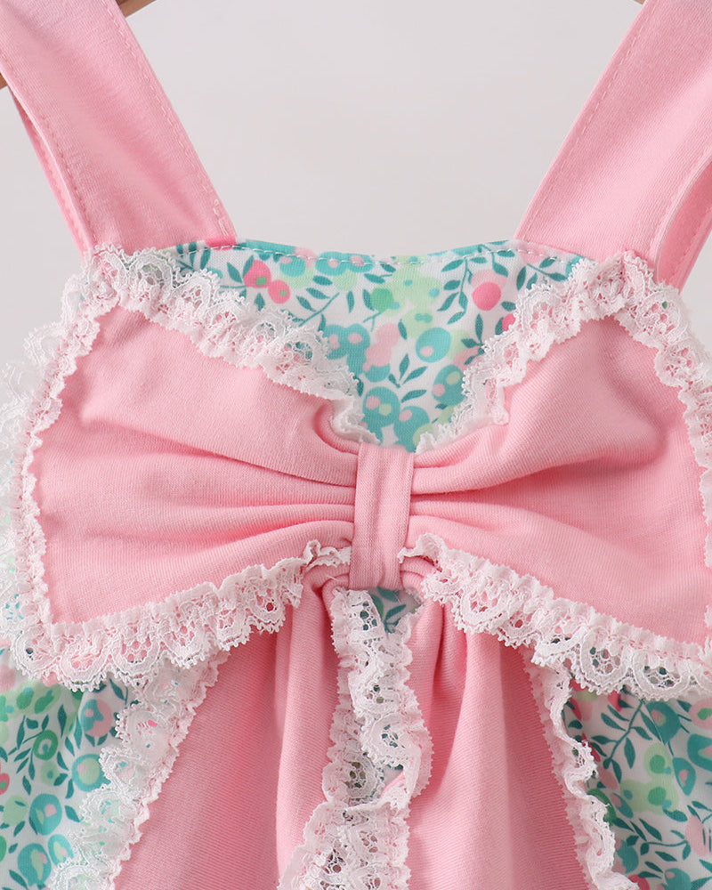 Pink dress with floral and lace details on a white background