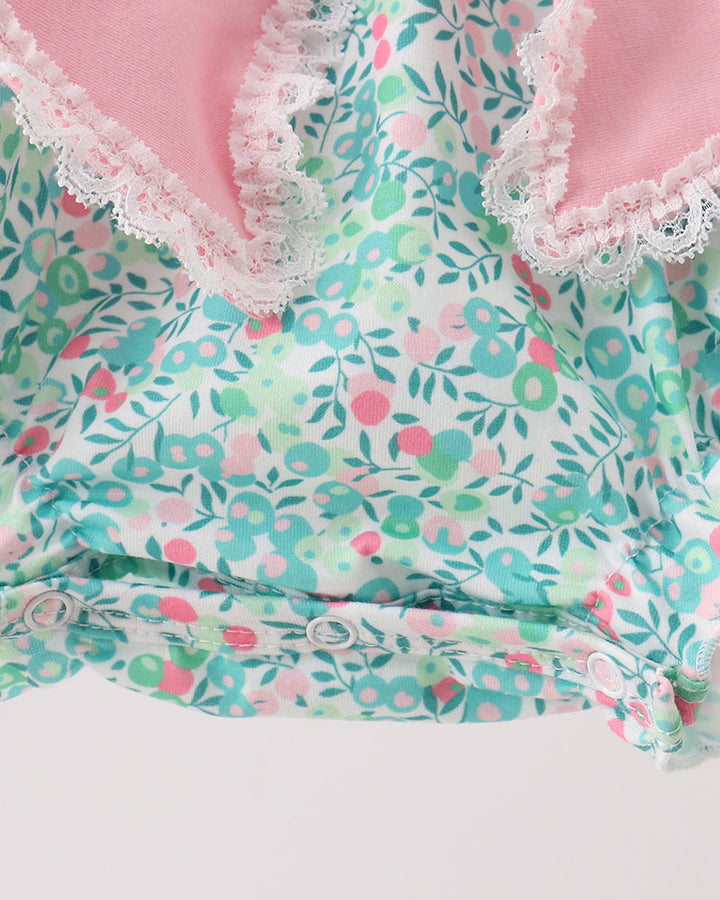 Floral patterned fabric with lace trim on a light background
