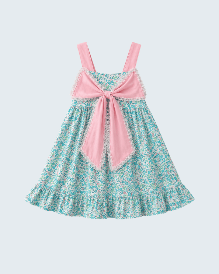 Floral dress with pink bow on a light gray background