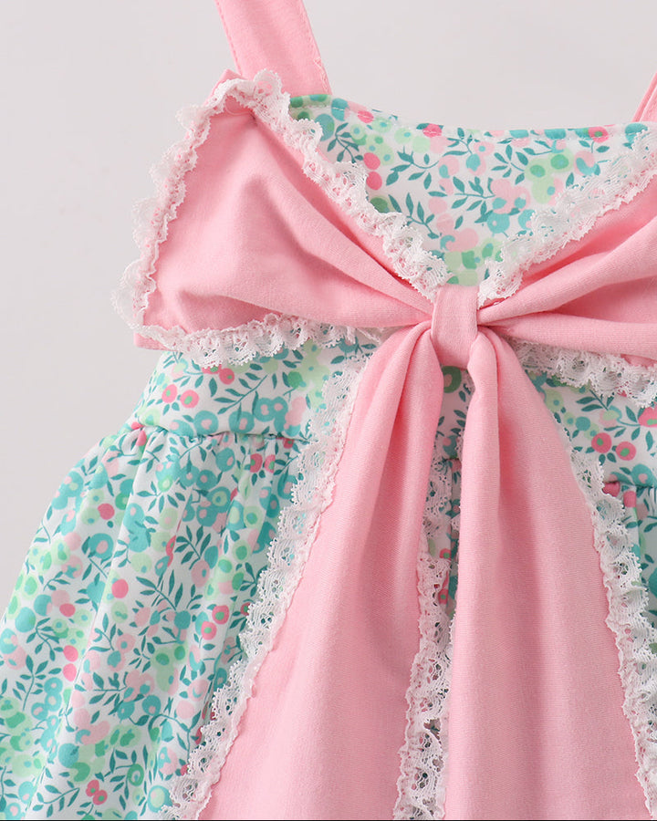 Floral dress with a large pink bow on a white background