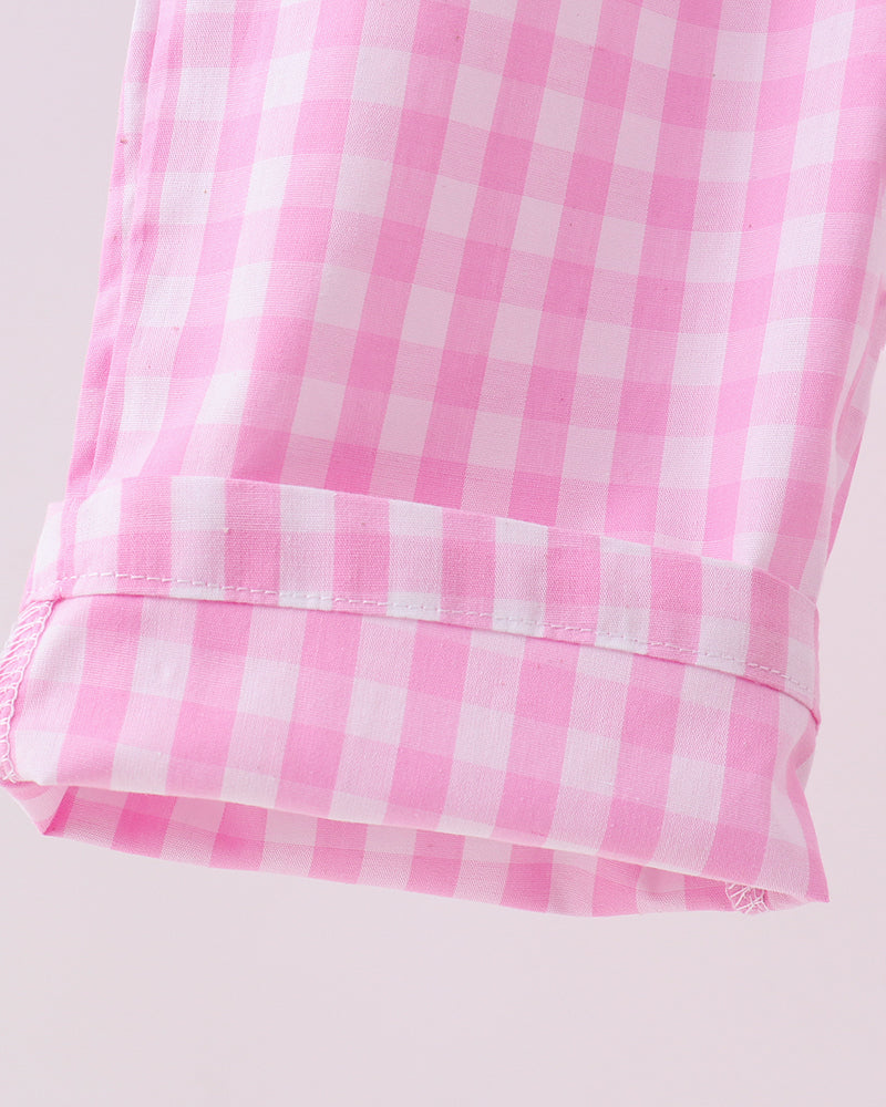 Close-up of a pink and white checkered fabric on a light gray background