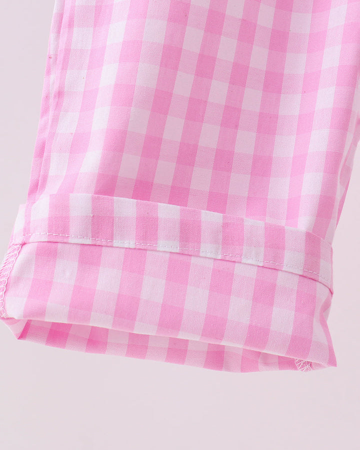 Close-up of a pink and white checkered fabric on a light gray background