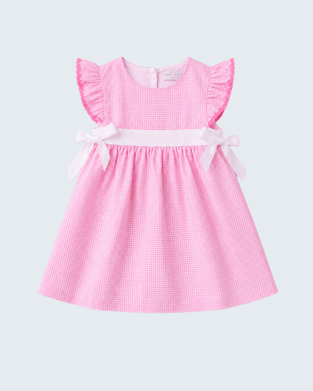 Pink checkered dress with ruffled sleeves on a light gray background