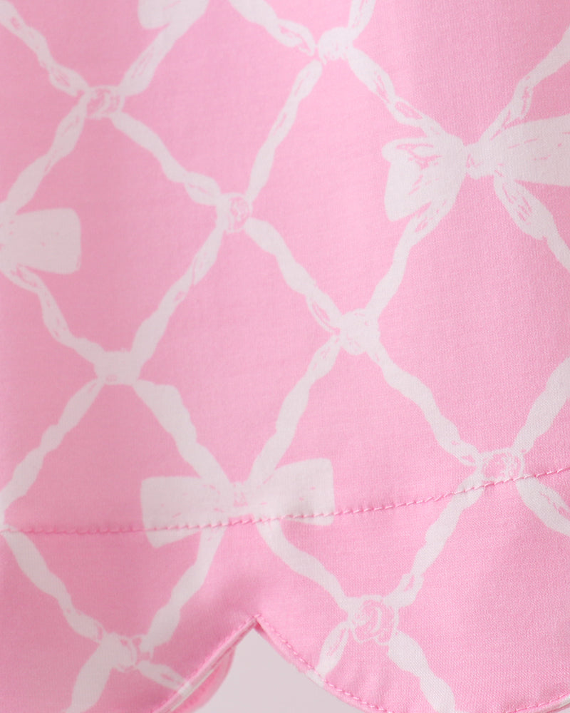 Close-up of pink fabric with white geometric pattern