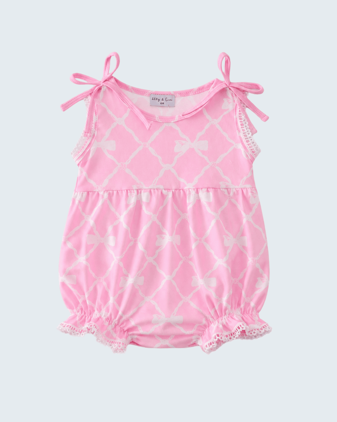 Pink baby romper with white lattice pattern on a light gray background