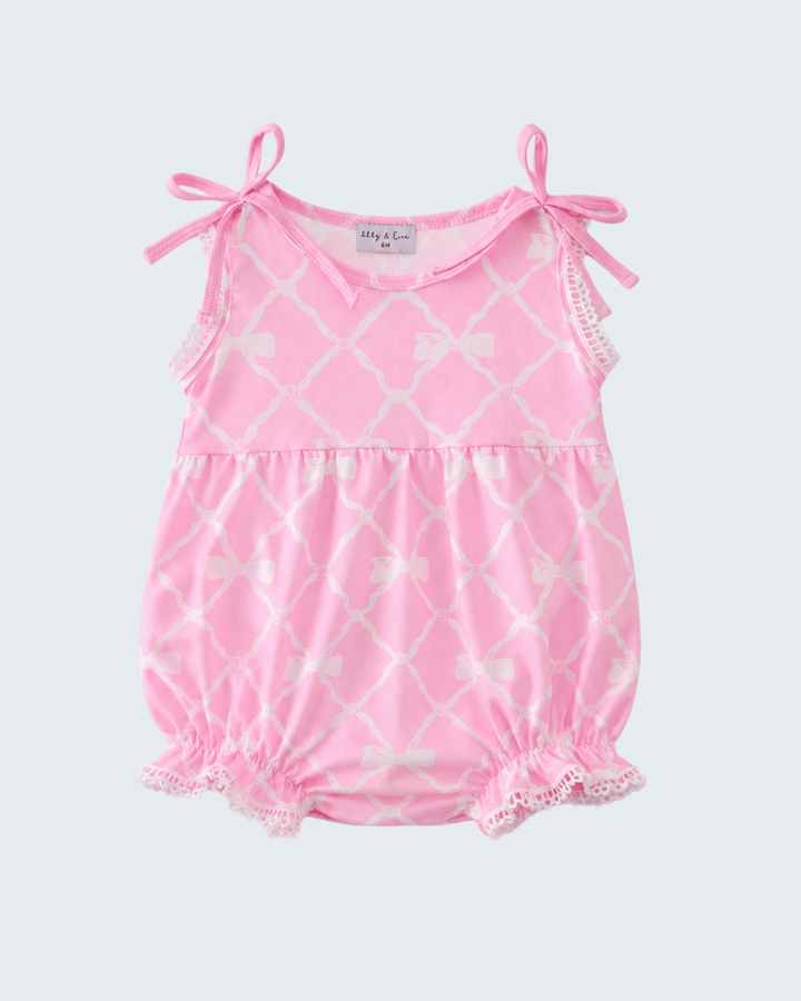 Pink baby romper with white lattice pattern on a light gray background