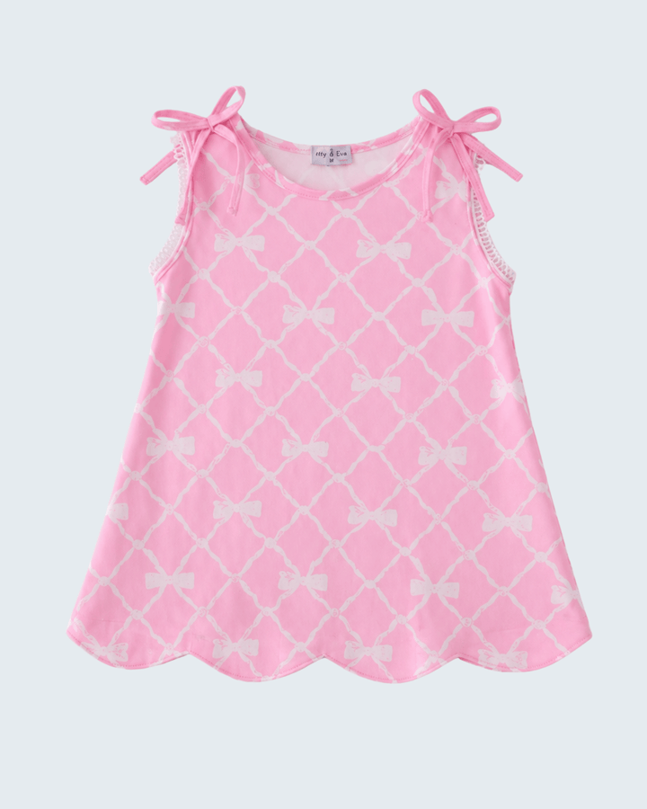 Pink dress with white bow pattern on a white background