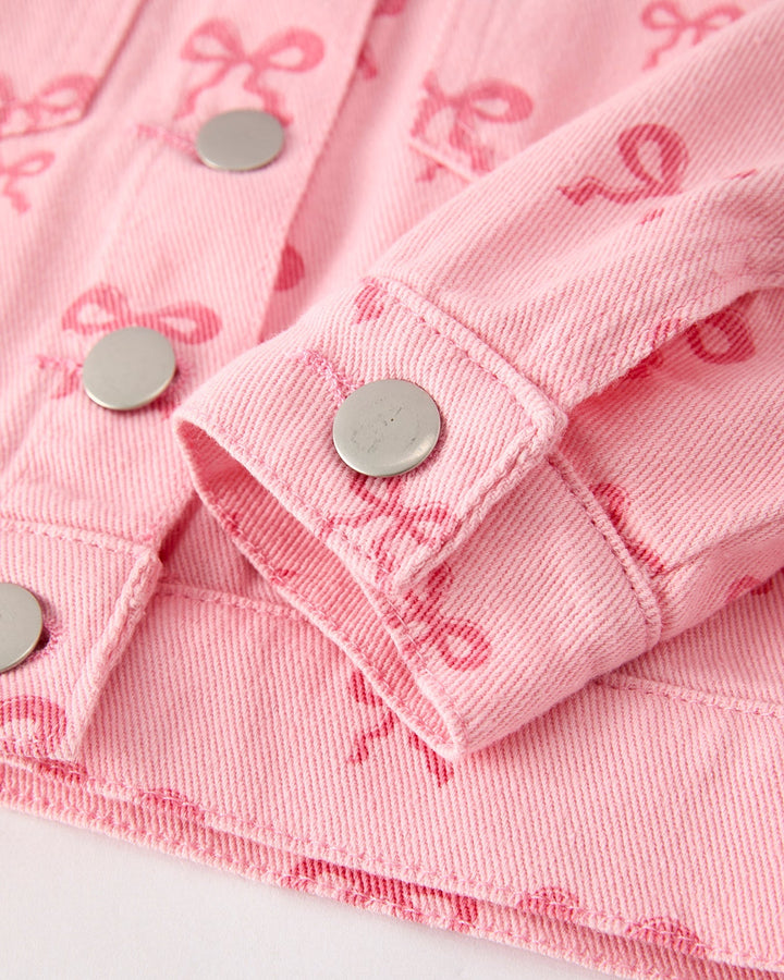 Pink girls denim jacket close-up: button cuffs and bow print