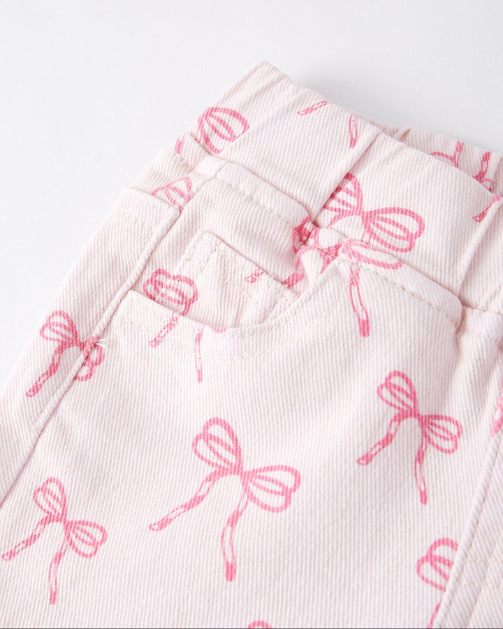 Girls flared jeans close-up with pink bow print and elastic waistband detail