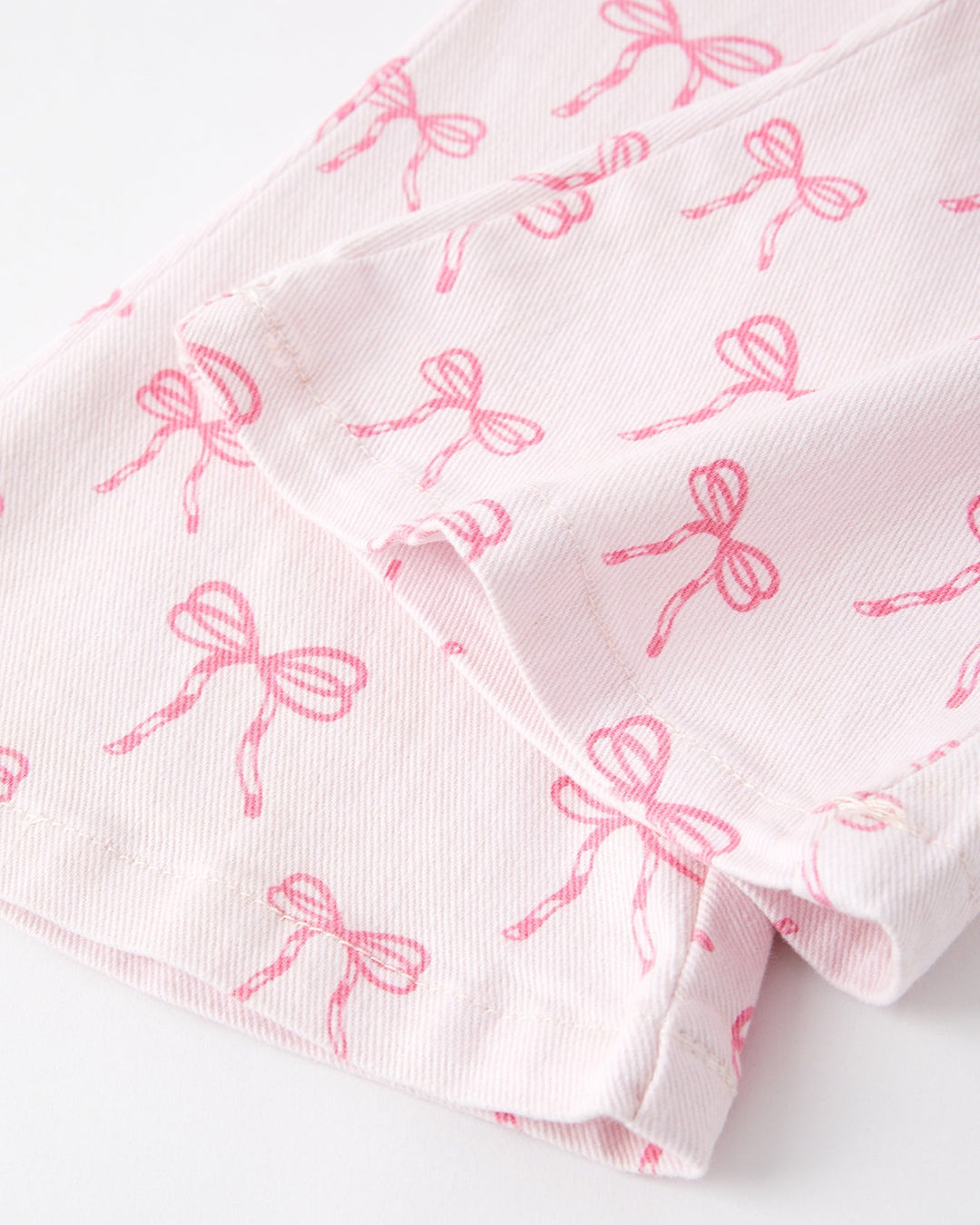 Girls flared jeans with pink bow print, cuff and hem detail