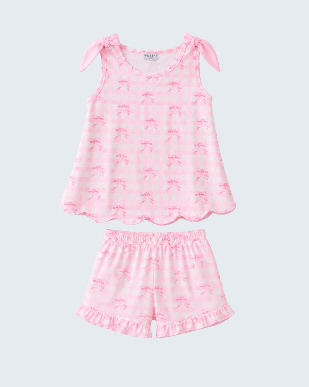 Pink shorts set with bow details on a white background