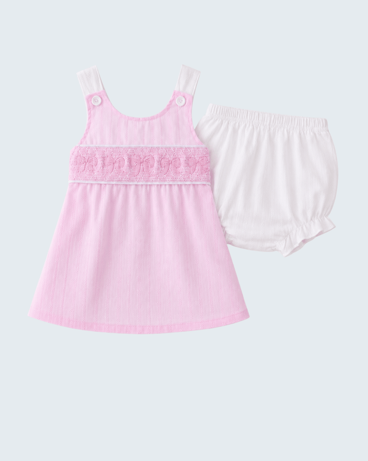 Pink tank top and white shorts set on a light gray background