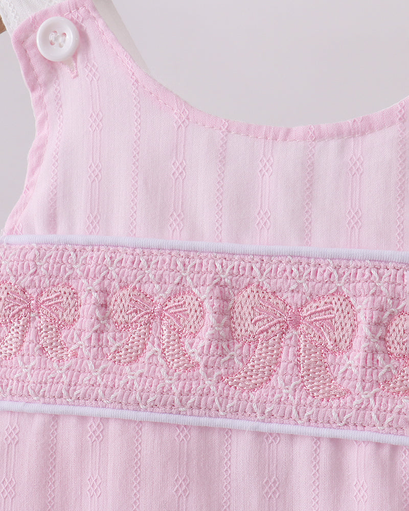 Close up of bow embroidery on shirt