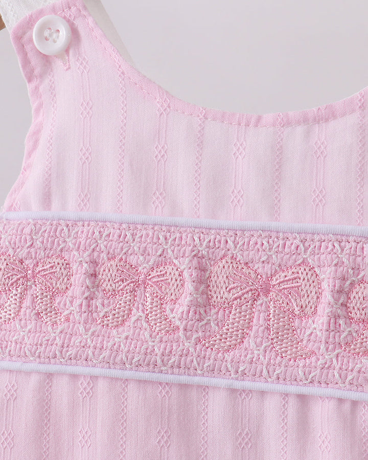 Close up of bow embroidery on shirt