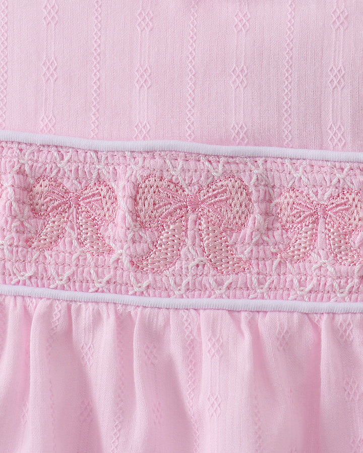 Close up of bow embroidery on romper