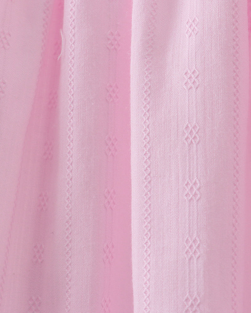 Close-up of pink fabric with a subtle pattern