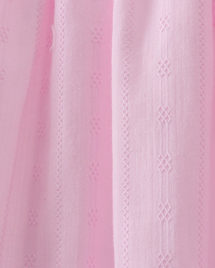 Close-up of pink fabric with a subtle pattern