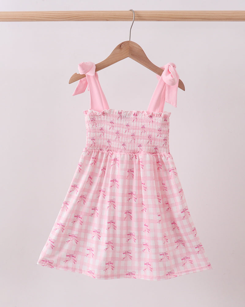 Pink Bow Smocked Ruffle girls Dress on wooden hanger