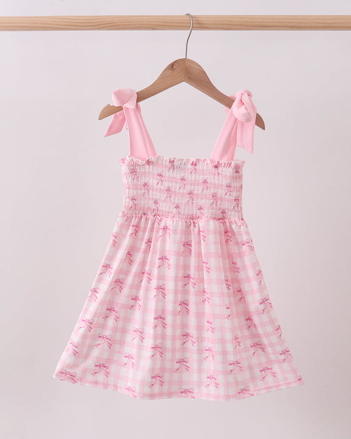 Pink Bow Smocked Ruffle girls Dress on wooden hanger