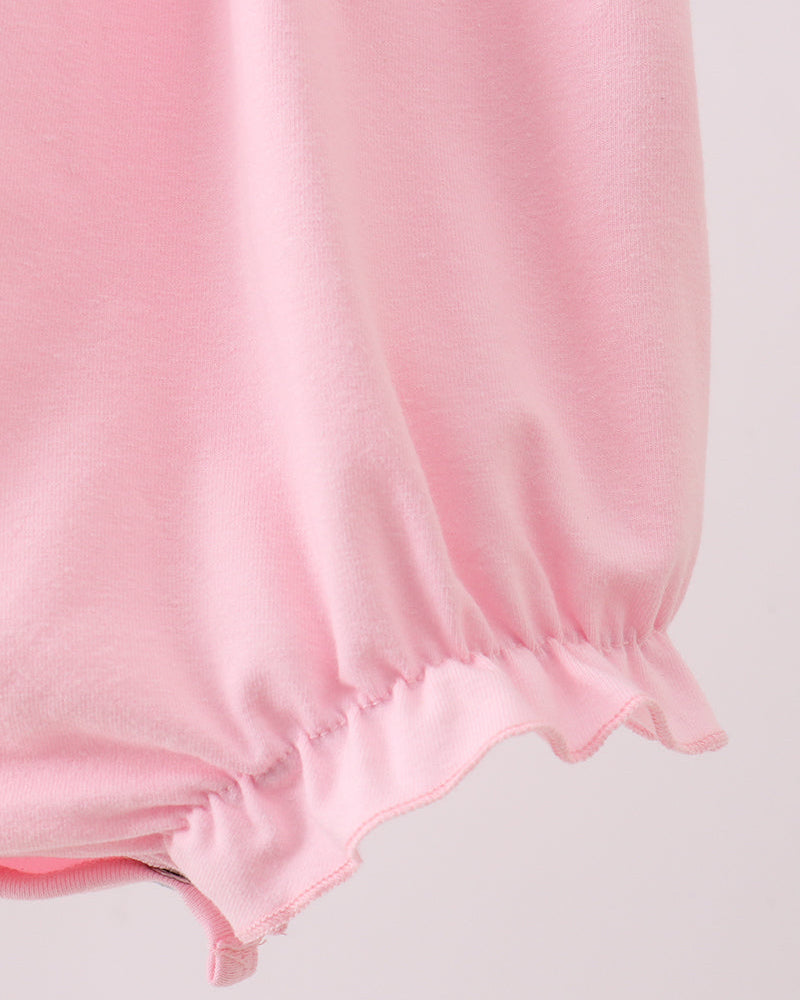 Close-up of a pink fabric with a light gray background