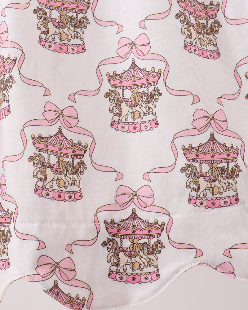 Fabric with carousel and bow pattern on a white background