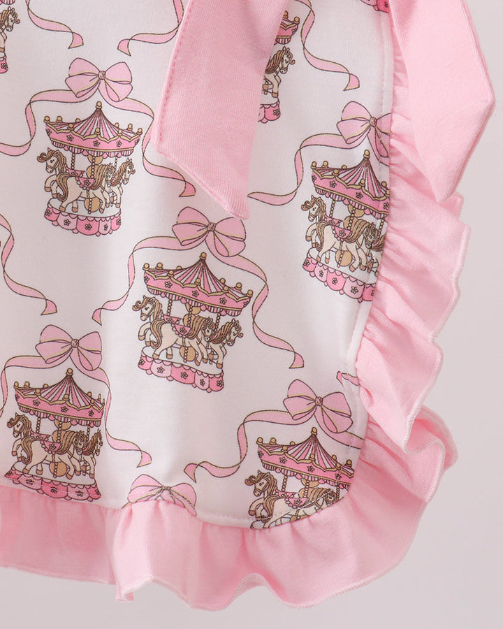 Girls top with carousel and bow design on a white background