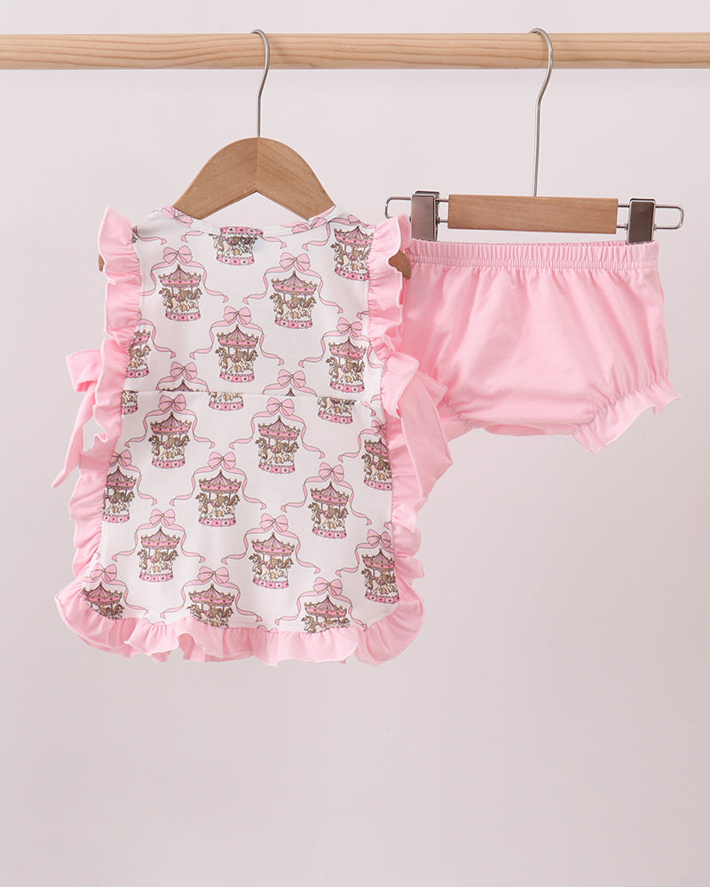 Baby romper with ruffles and pink bloomers on hangers against a light gray background