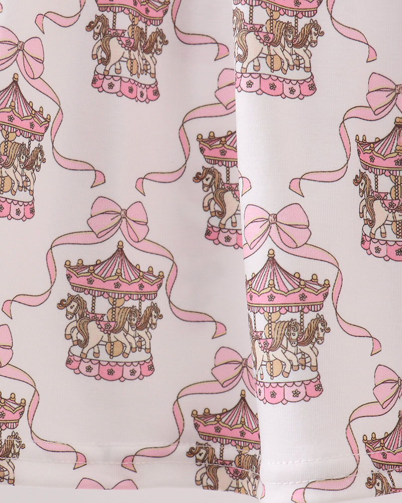 Pattern of carousel horses with pink ribbons on a white background