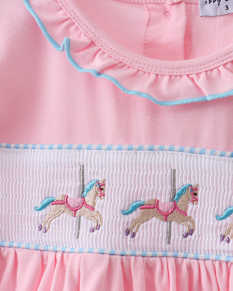 Pink dress with embroidered horses on a white background