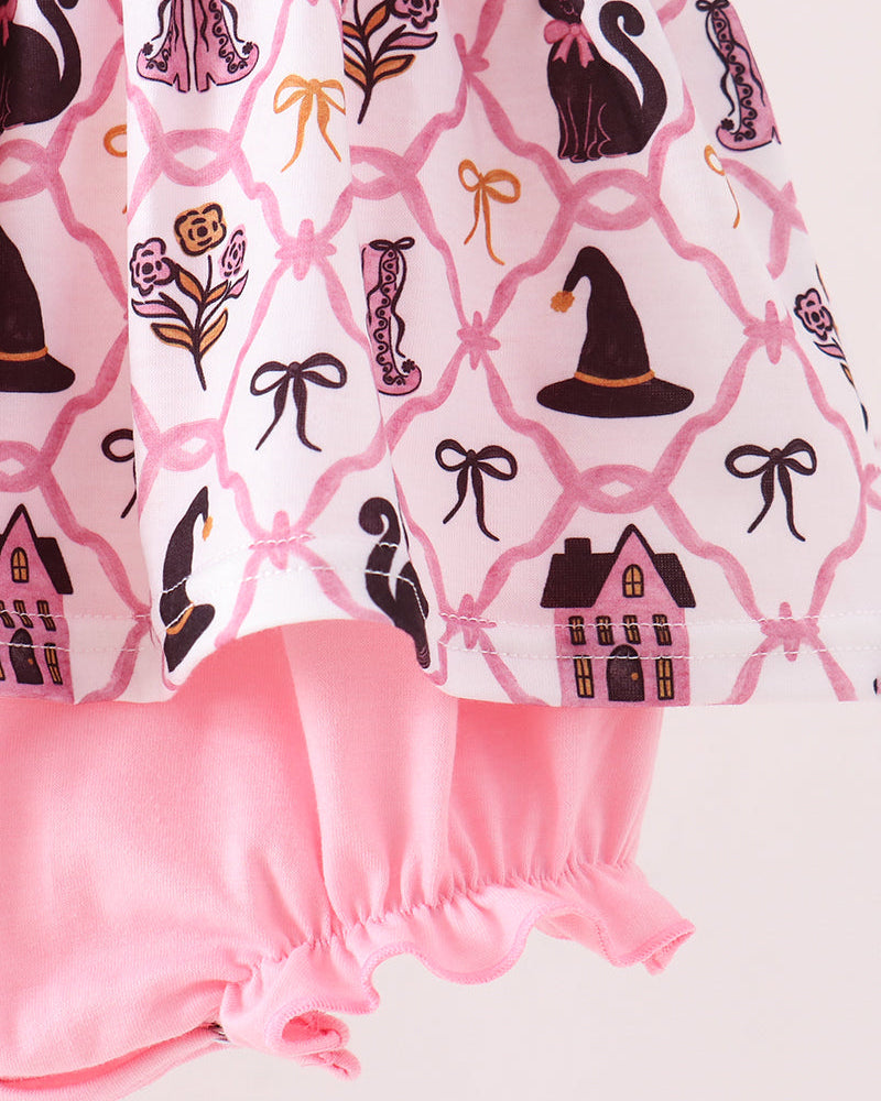 Pink and white patterned dress with black witch motifs, including a cat, witch hat, house, and flowers, paired with solid pink ruffled bloomers.