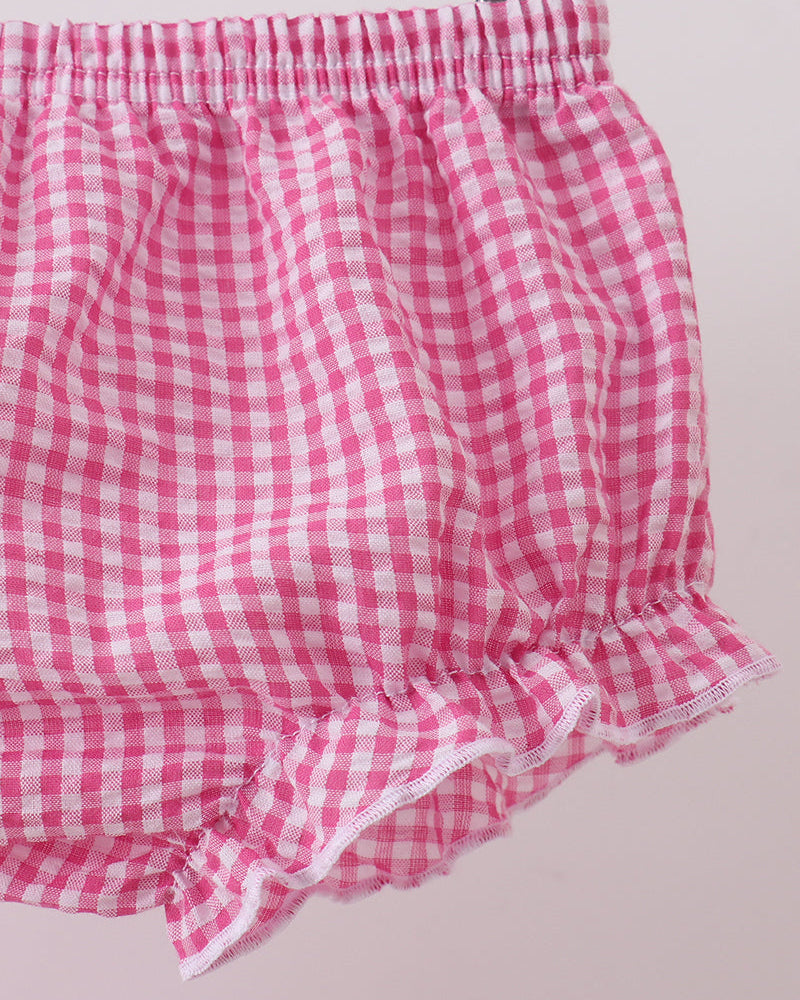 Pink and white checkered bloomers on a light pink background