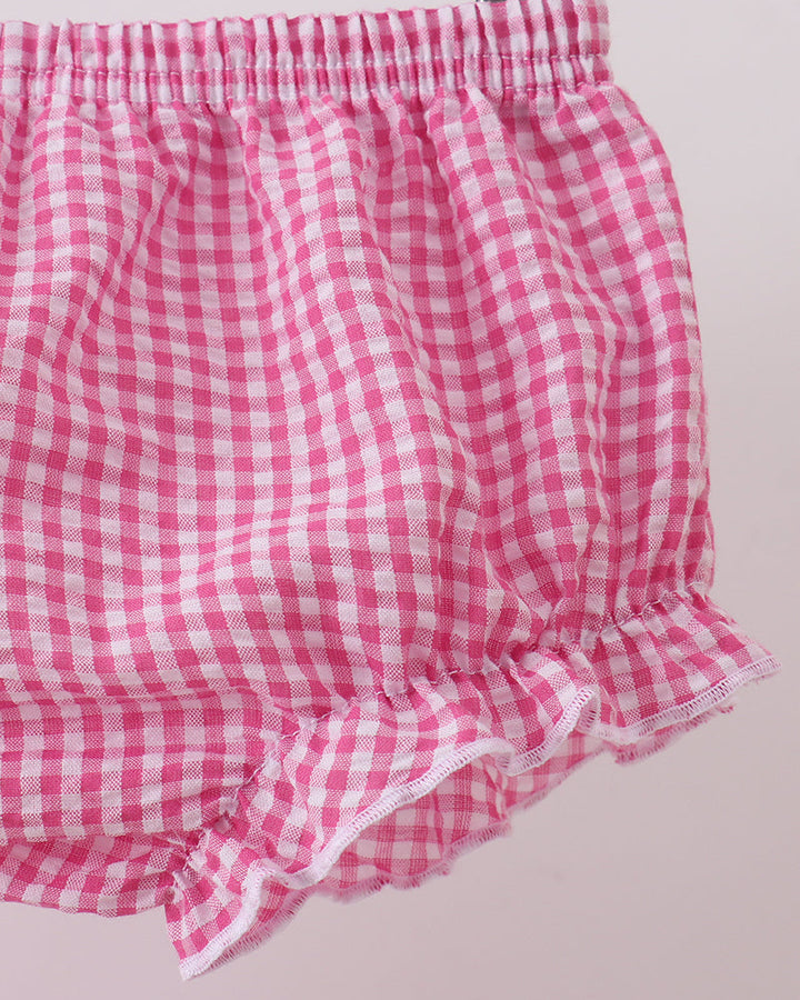 Pink and white checkered bloomers on a light pink background