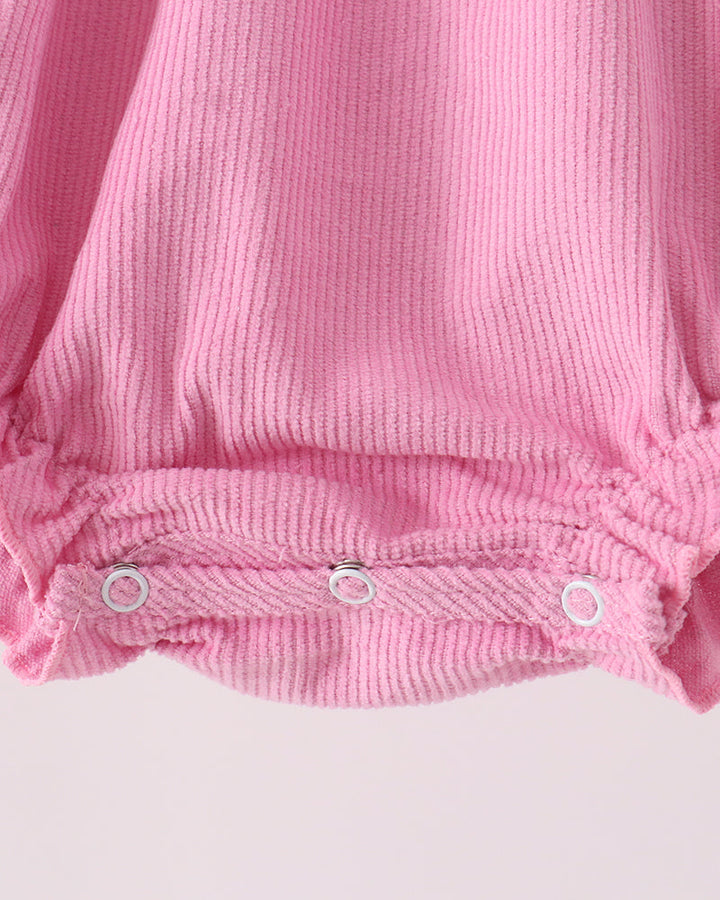 Pink corduroy bubble romper with smocked waist and snap-button bottom