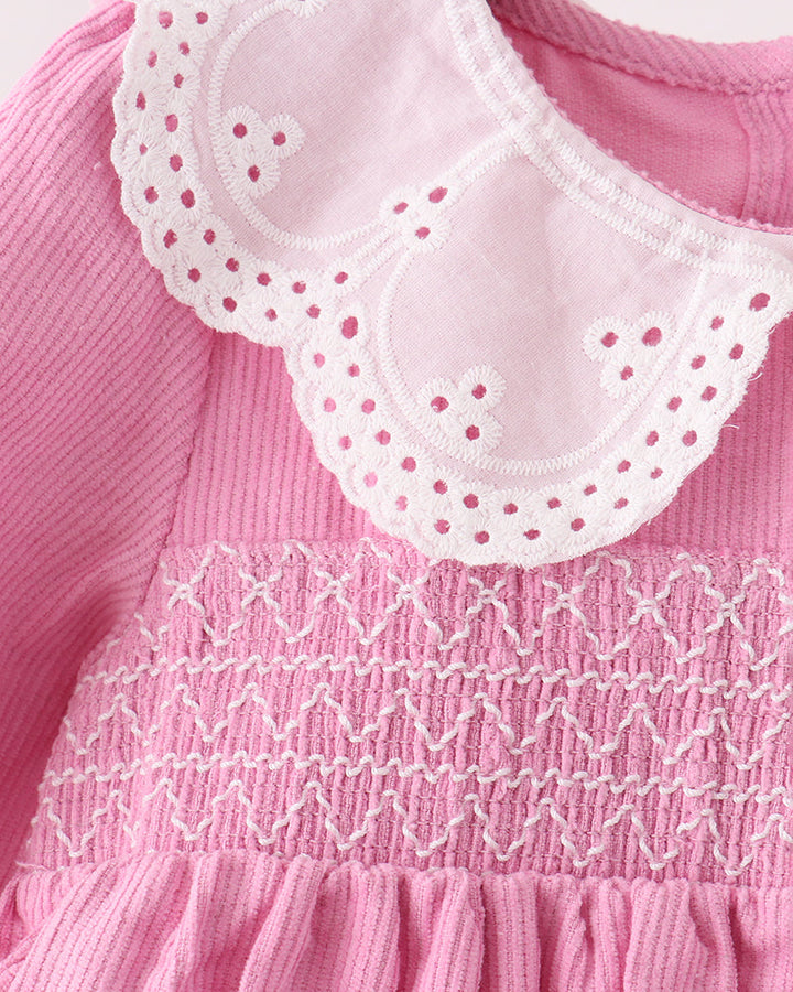 Pink corduroy dress with white lace peter pan collar and smocked bodice