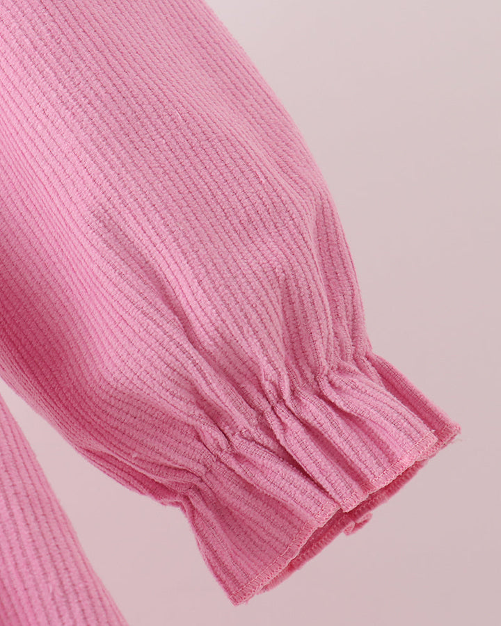 Pink corduroy dress sleeve with gathered ruffle cuff