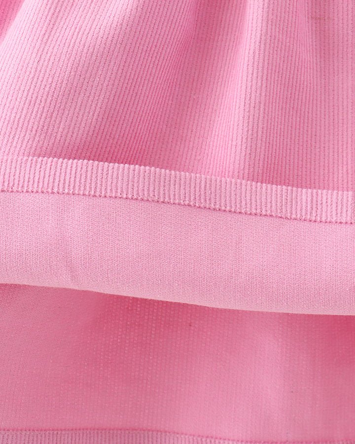 Pink corduroy dress hem with elastic waist band and tiered skirt