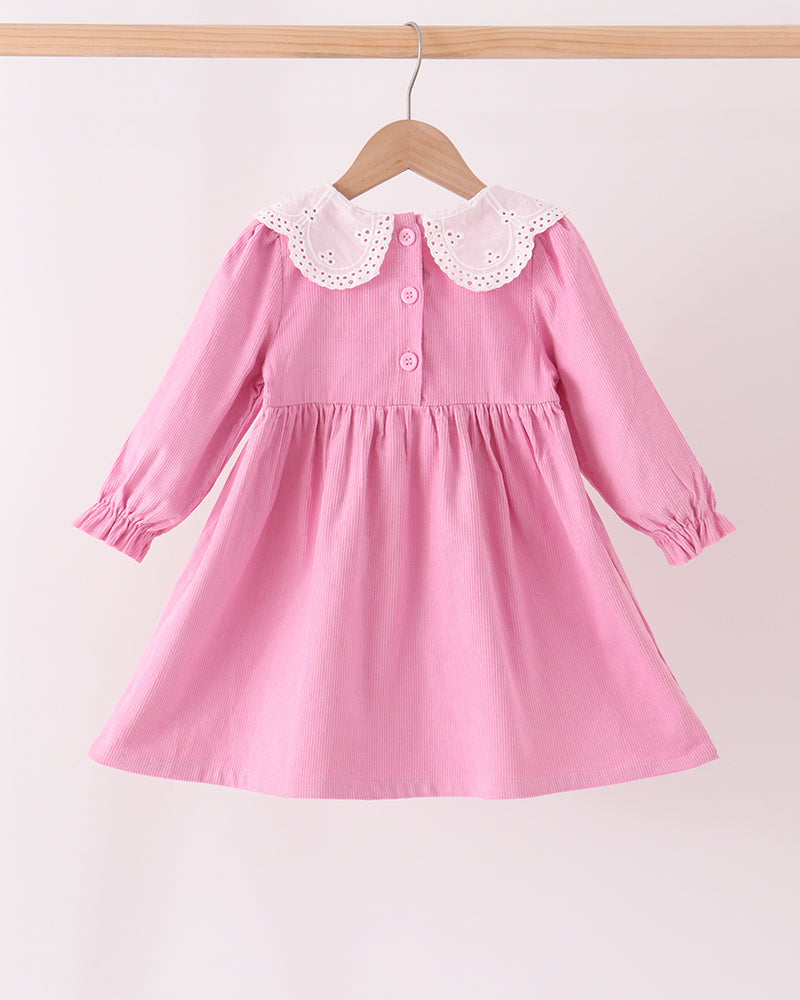 Pink corduroy baby dress with lace collar, button placket, and gathered skirt