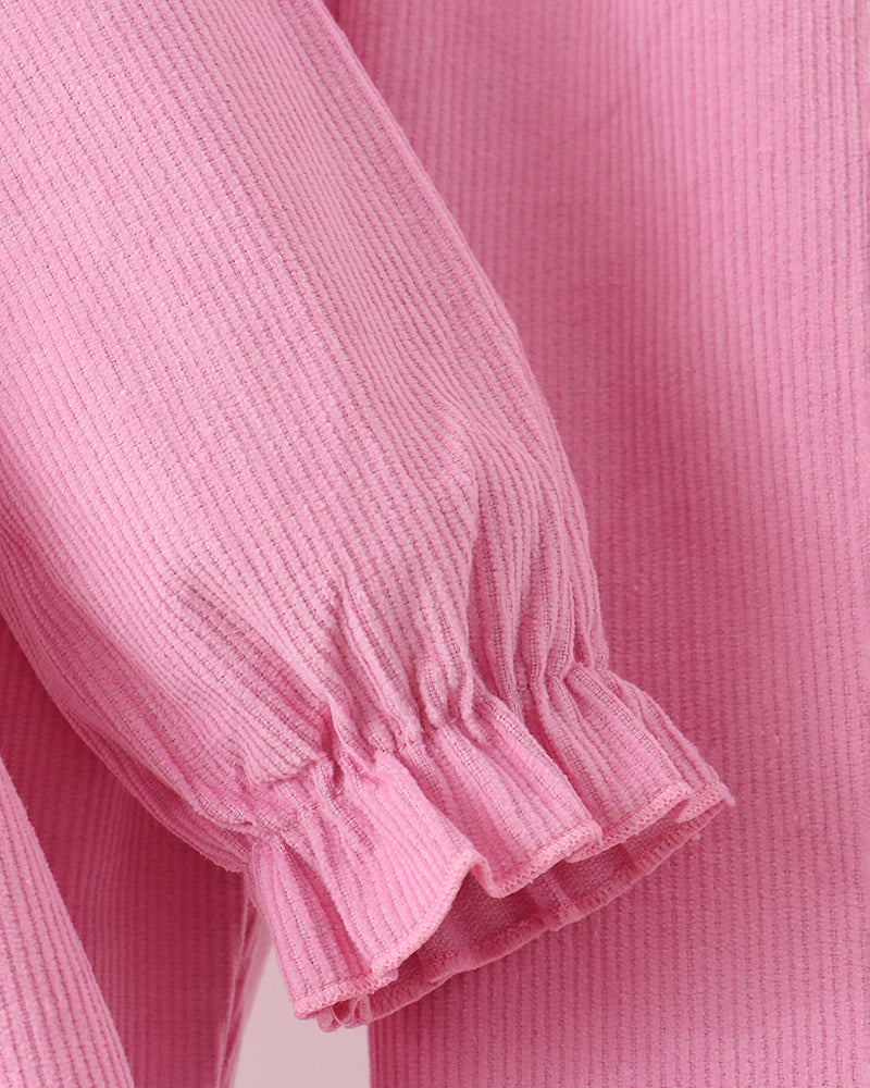 Pink corduroy pants with ruffled cuff hems and smocked gathered seams