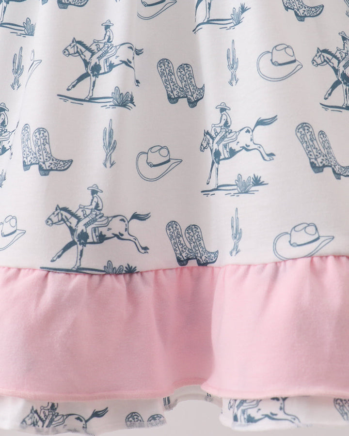 Girls dress with cowboy pattern and pink border on a white background