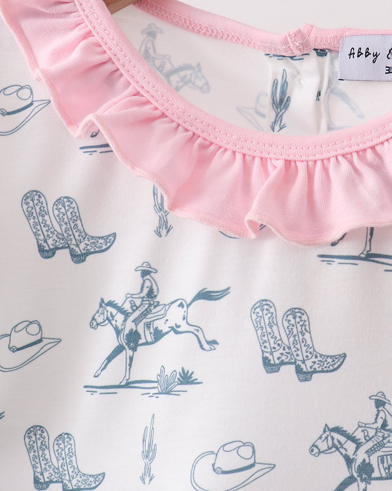 Baby outfit with cowboy print and pink ruffled trim, featuring brand label.